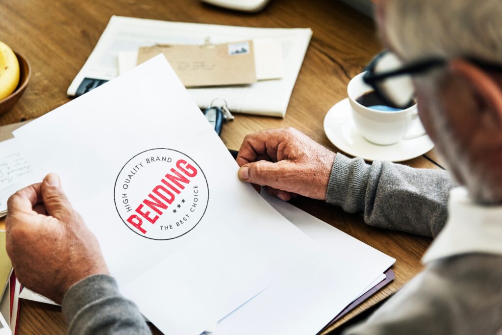 A homeowner reviews a pending real estate document while considering selling without paying realtor commissions.